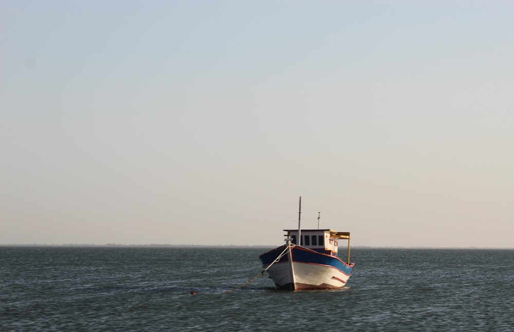 white and brown boat on sea during daytime