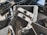A collection of disassembled and broken smartphone screens and components, primarily displaying the front side of various devices. The parts are scattered in a disorderly manner, displaying signs of wear and damage, including cracked screens and exposed internal circuitry.