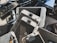 A collection of disassembled and broken smartphone screens and components, primarily displaying the front side of various devices. The parts are scattered in a disorderly manner, displaying signs of wear and damage, including cracked screens and exposed internal circuitry.