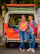 Group of happy travelers posing next to a comfortable tourist van.
