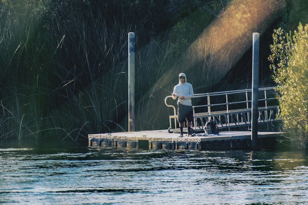 man and woman standing on dock during daytime