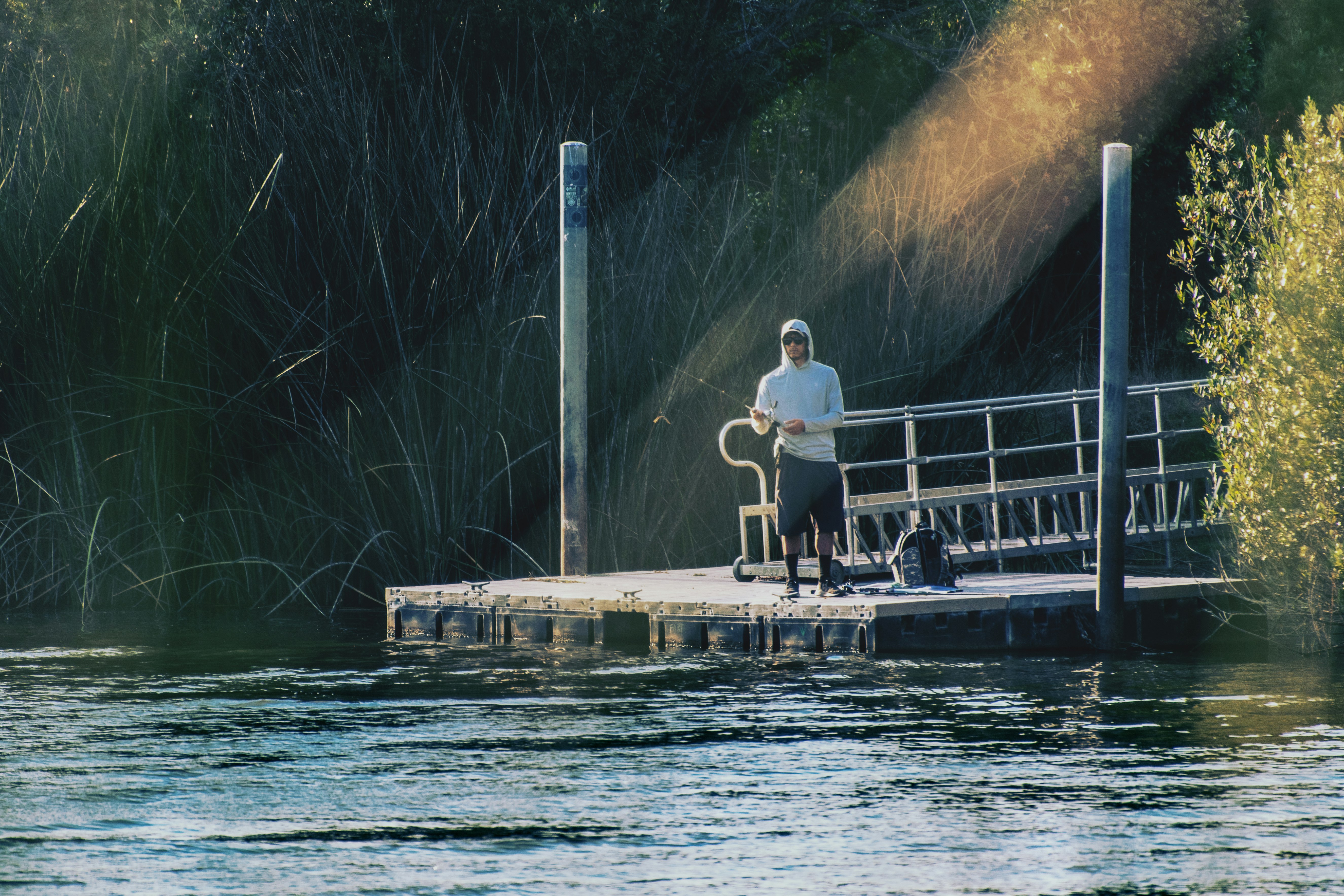 man and woman standing on dock during daytime