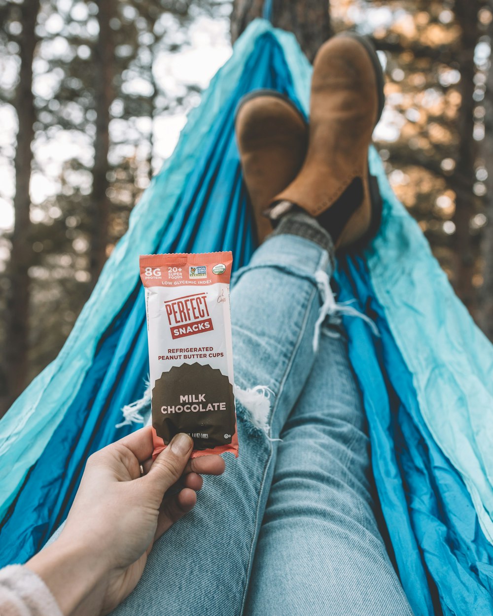 person holding white and red plastic pack