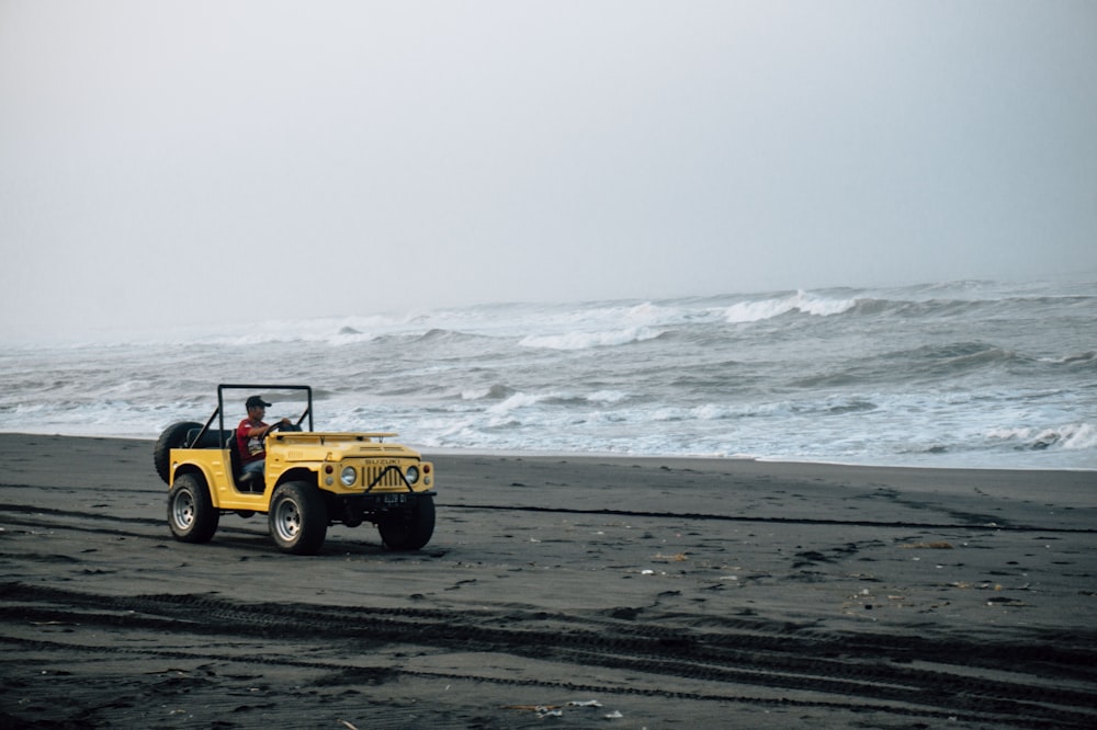 yellow jeep wrangler on beach during daytime