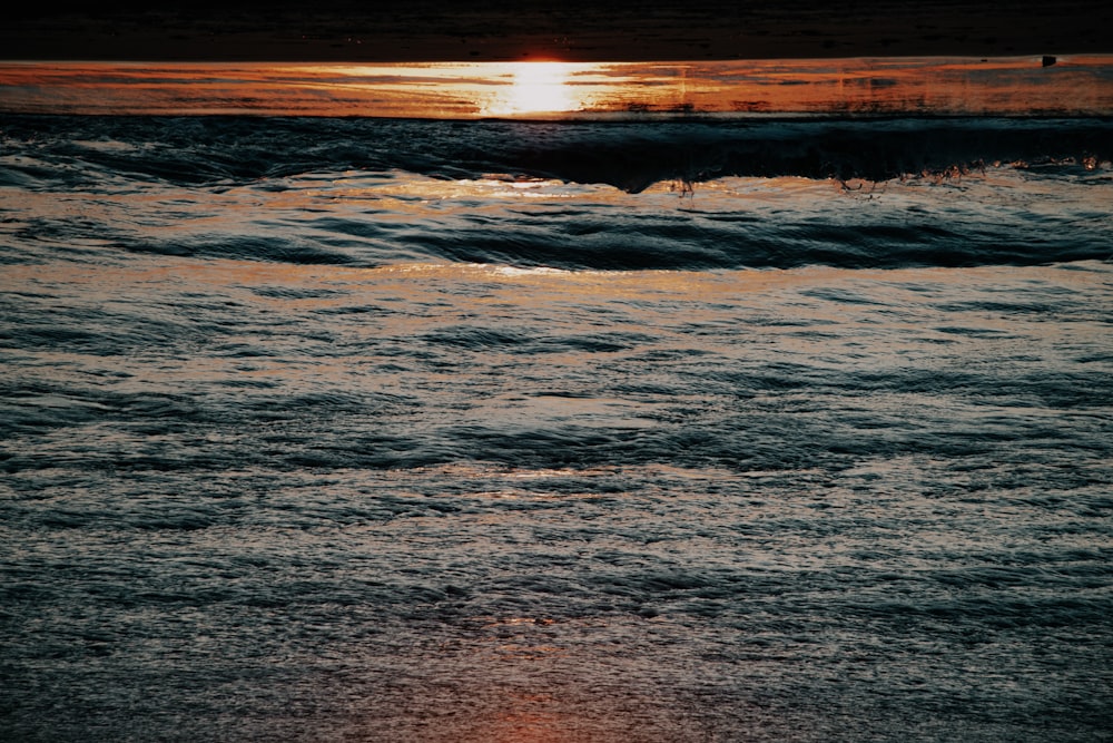 body of water during sunset