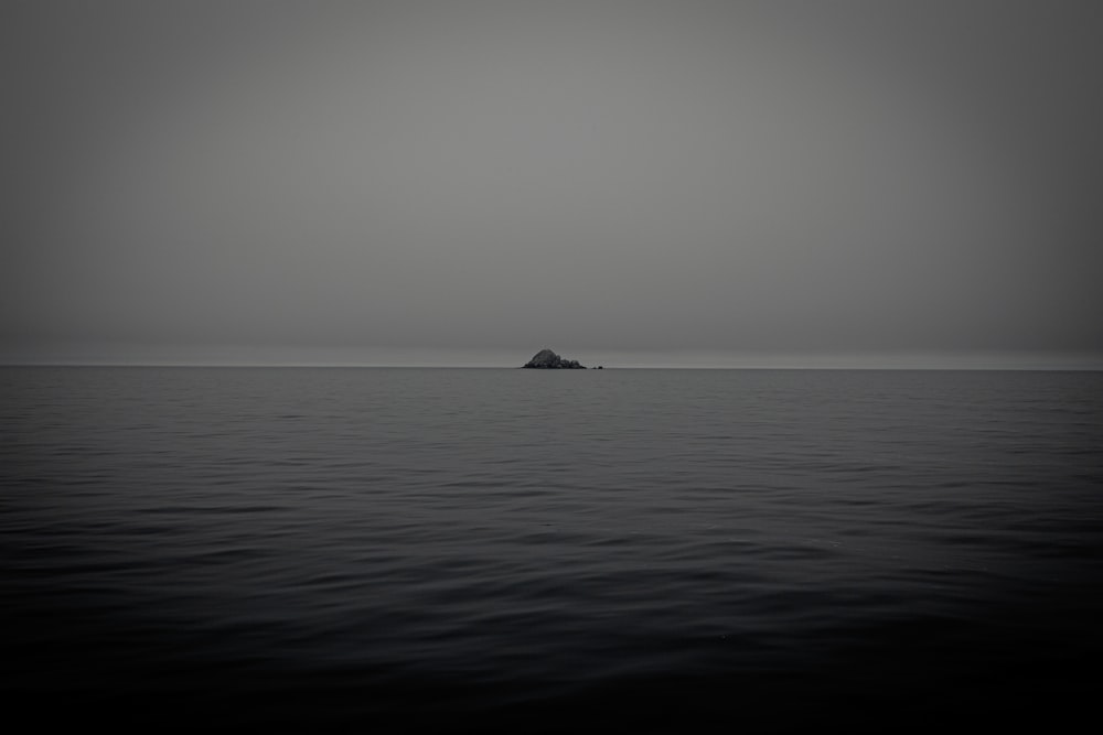 black boat on sea during daytime