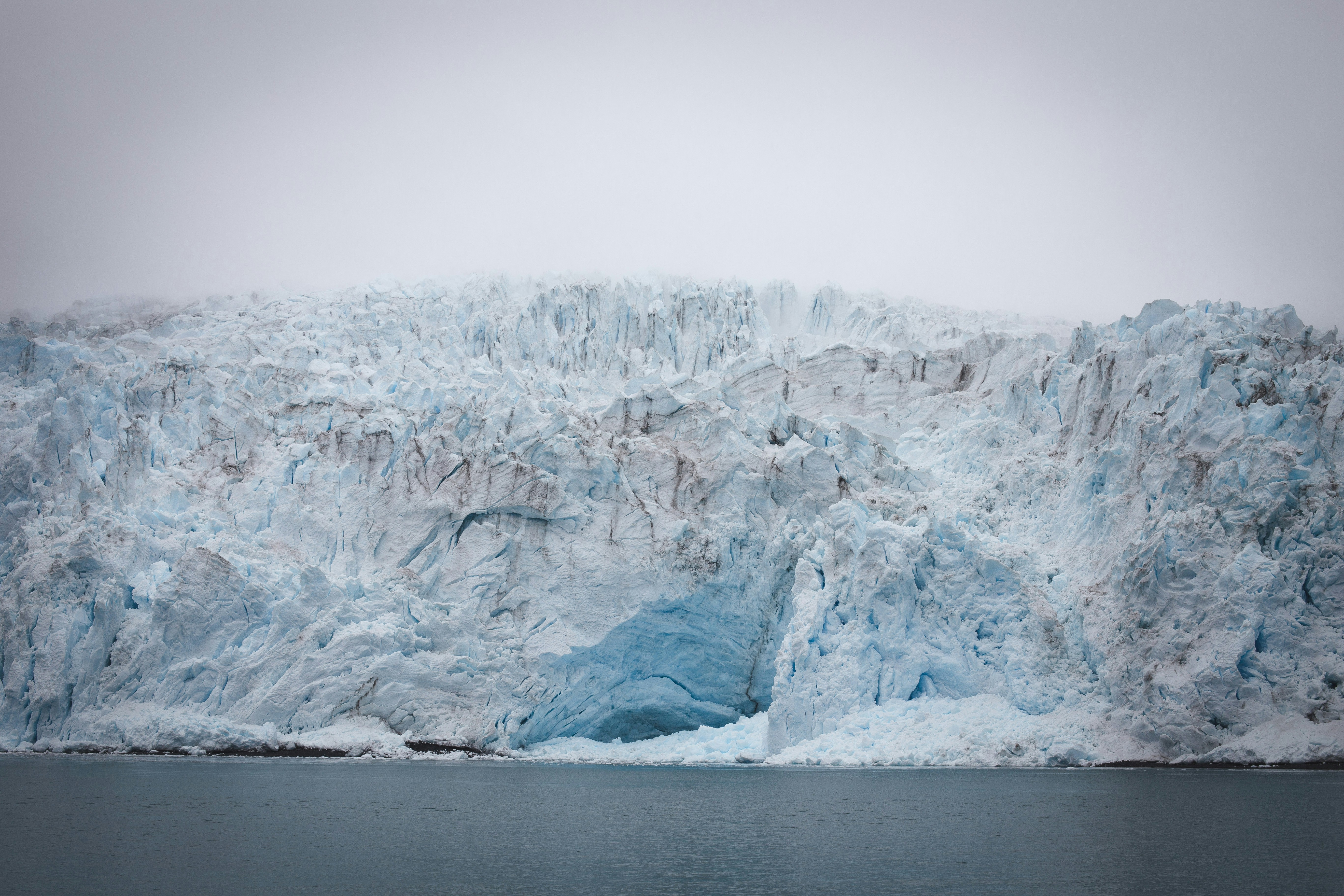 brown rock formation on body of water