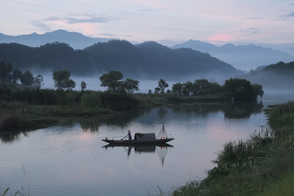 person riding on boat on lake during daytime