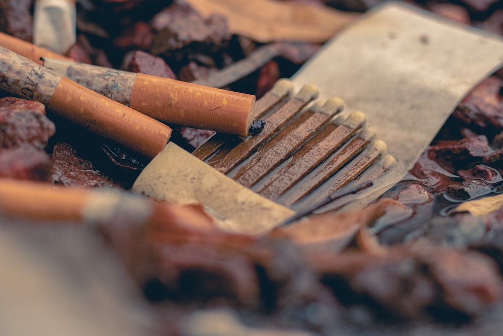 brown cigarette stick on brown surface