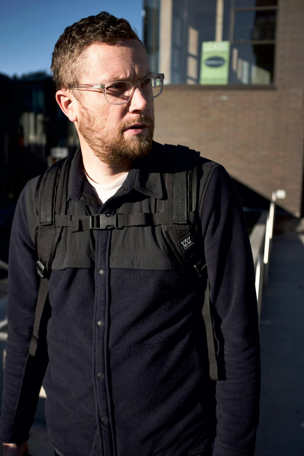 man in black dress shirt wearing black framed eyeglasses