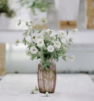 white flowers in brown wooden vase