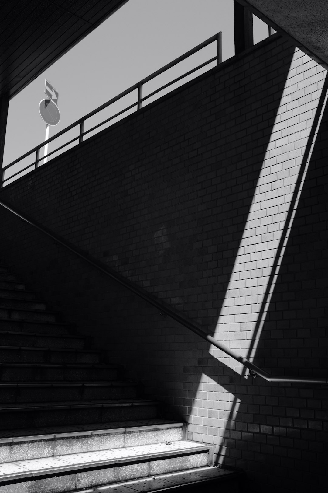 grayscale photo of brick wall