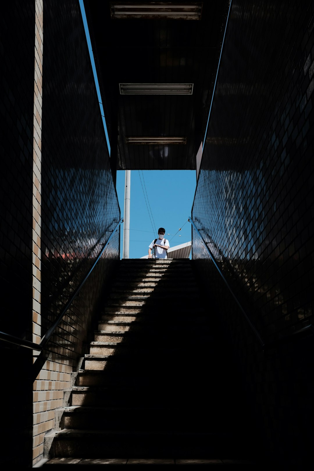 person in black shirt walking on hallway