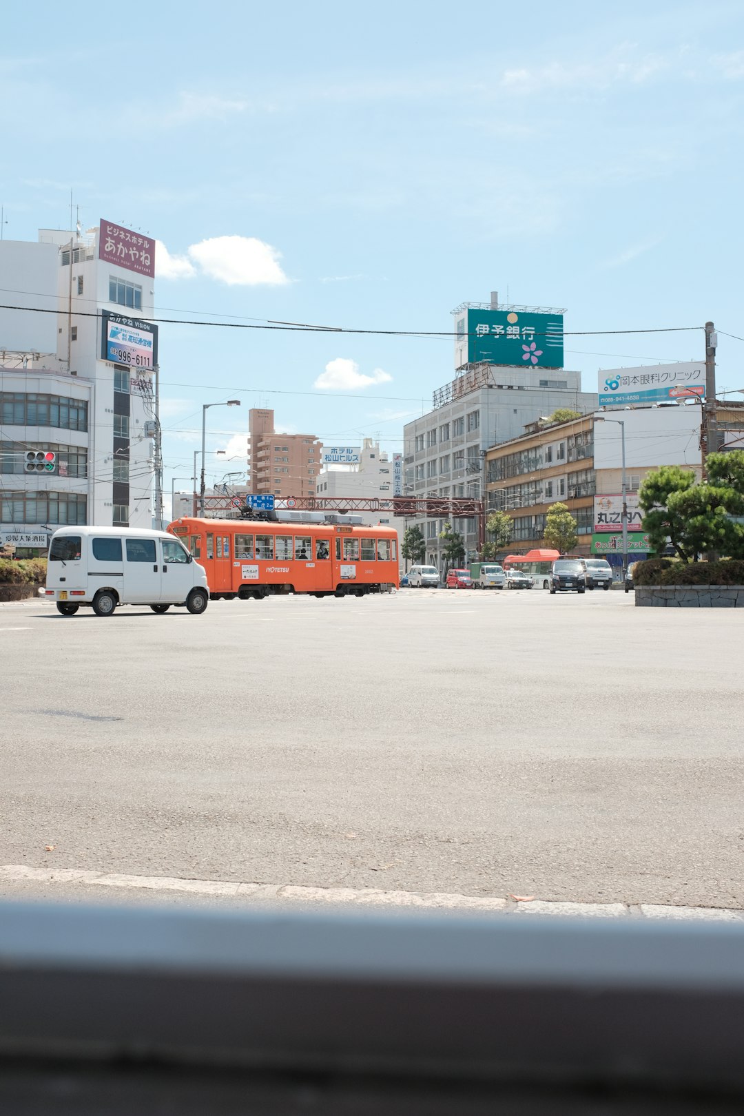 white and orange bus on road during daytime