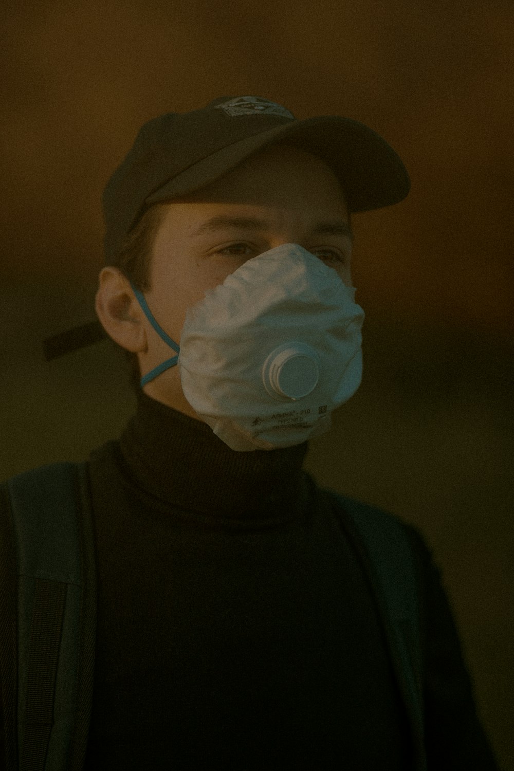 man in black shirt wearing white mask