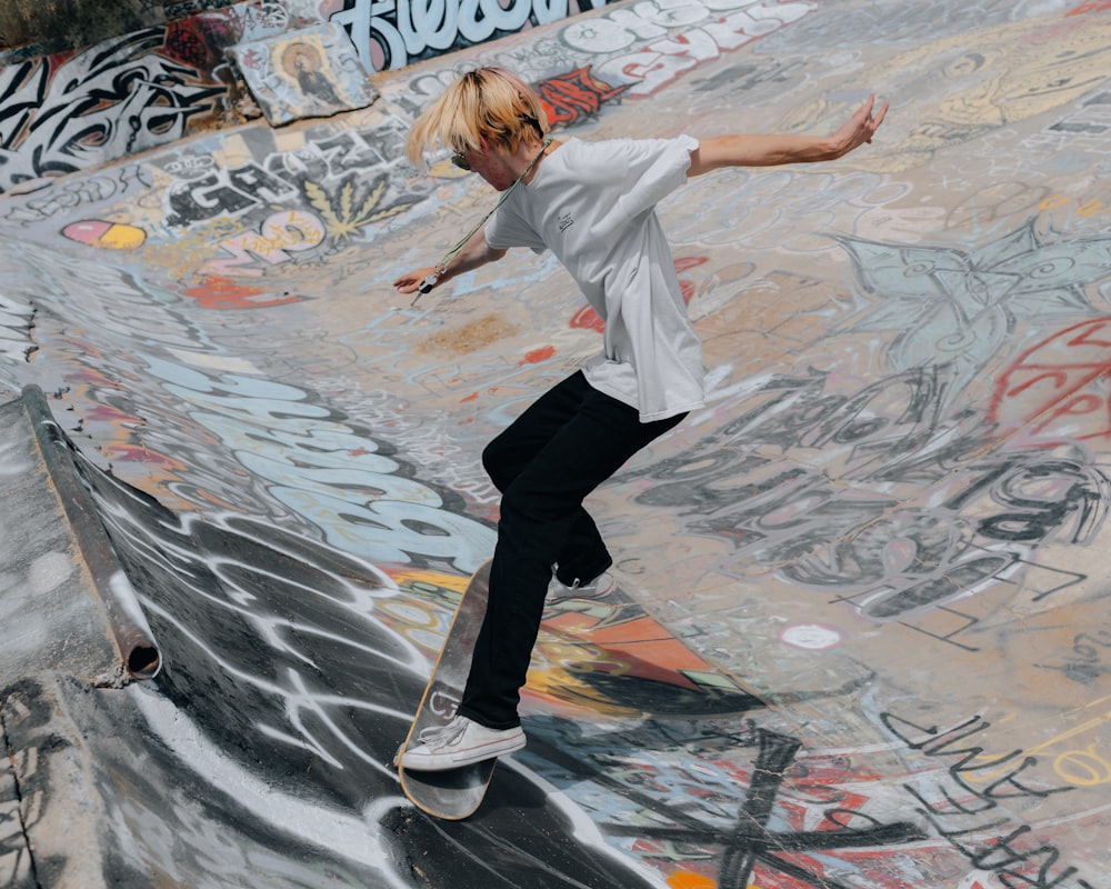 girl in white shirt and black pants standing on white and black concrete floor