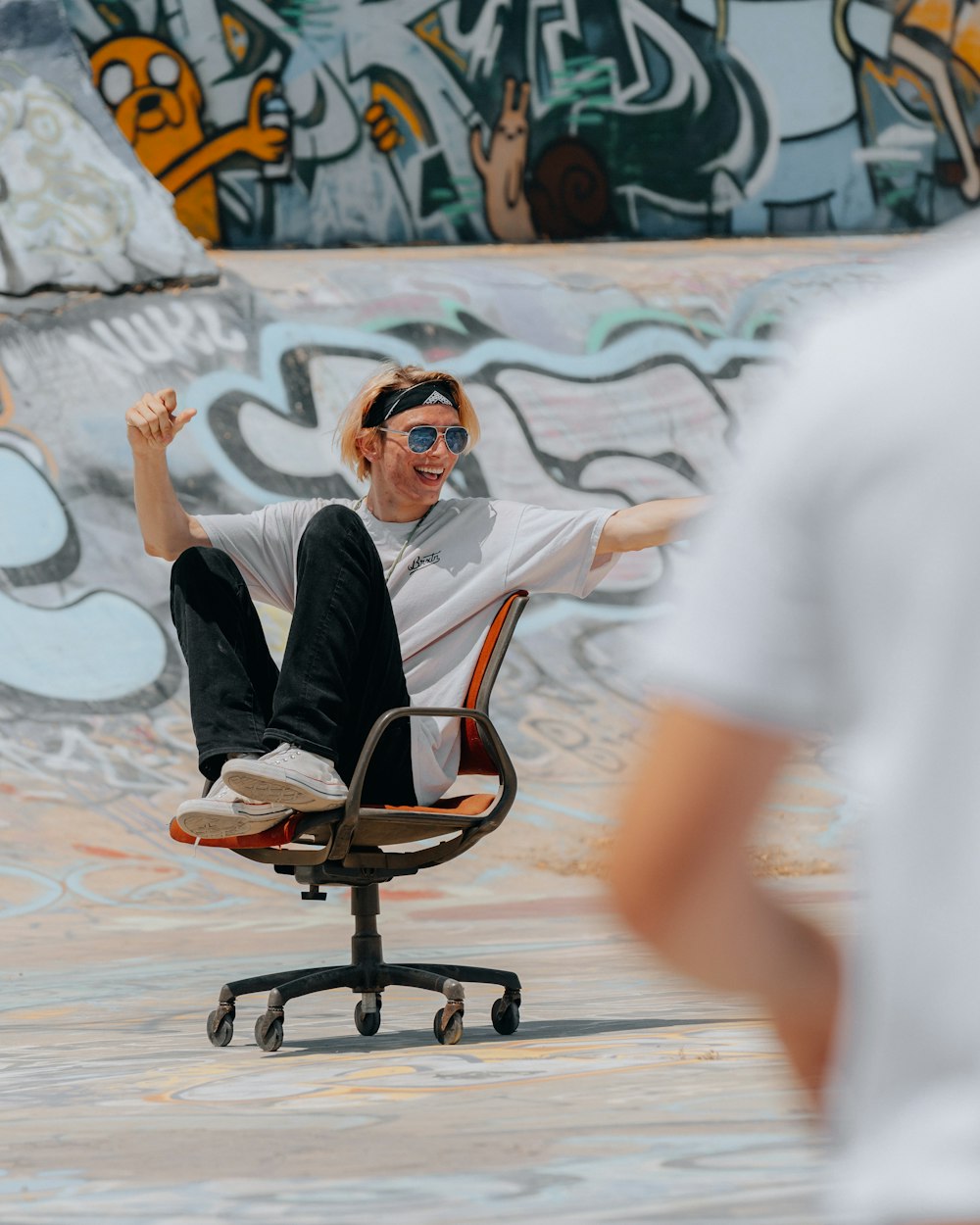 woman in black shirt sitting on orange rolling chair