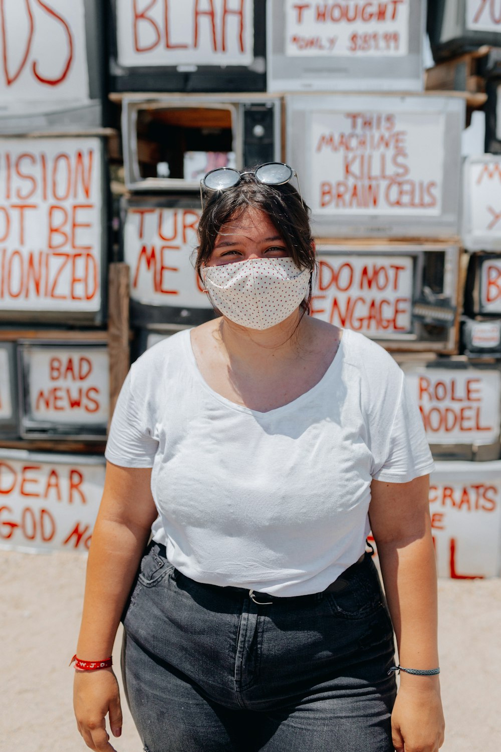 woman in white crew neck t-shirt and black pants wearing black sunglasses