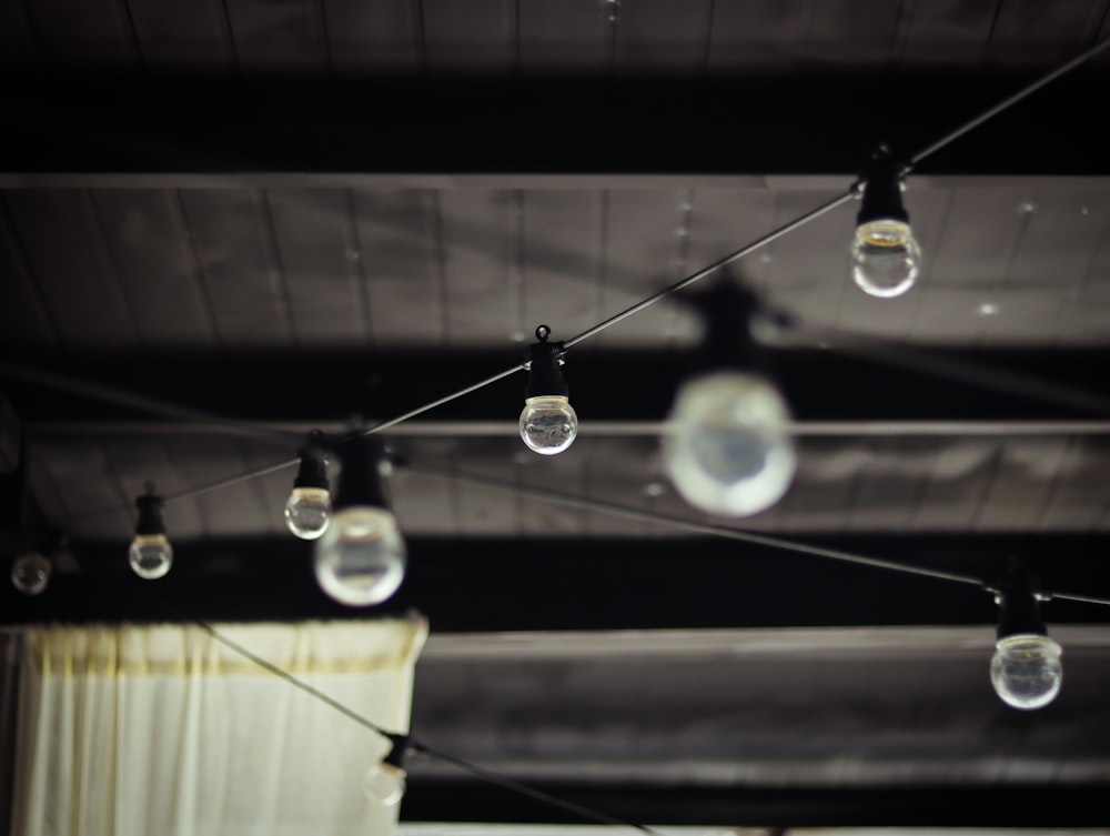 white string lights turned on in grayscale photography