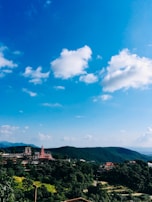 A scenic view of a historic Malaysian temple framed by lush greenery, taken from our tour vehicle.