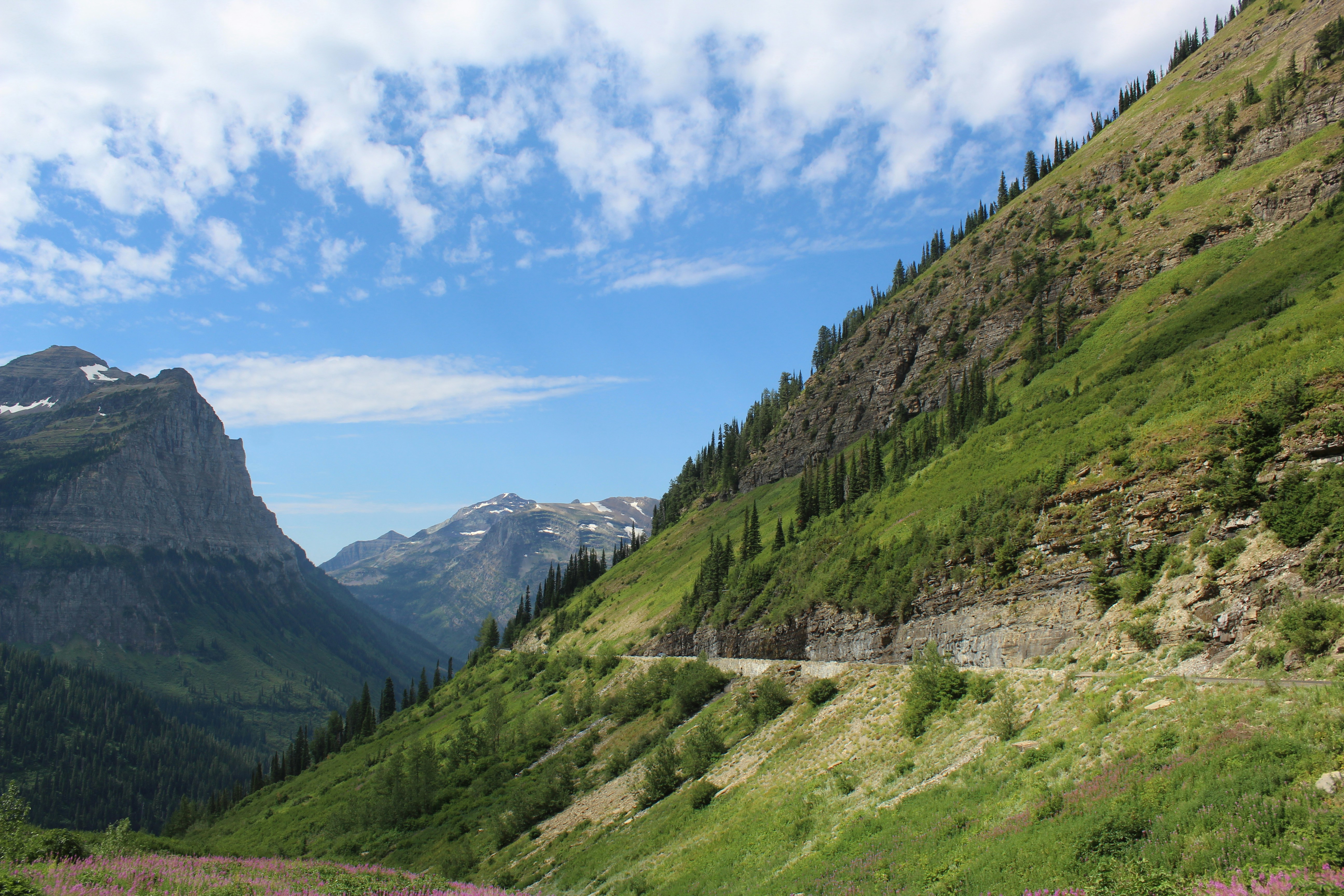 green mountains under blue sky and white clouds during daytime