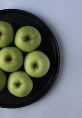 Agency team shooting photos of fresh produce in natural light with matte forest green backdrops.