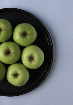 Agency team shooting photos of fresh produce in natural light with matte forest green backdrops.