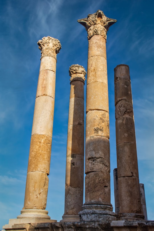 brown concrete pillar under blue sky during daytime in Jerash Jordan