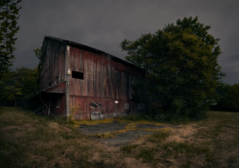 brown wooden barn under gray cloudy sky