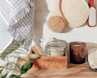 brown wooden chopping board beside clear glass jar