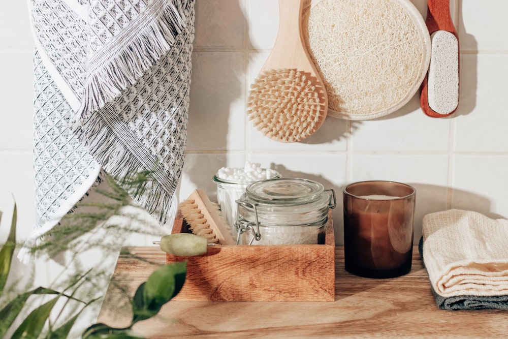 brown wooden chopping board beside clear glass jar