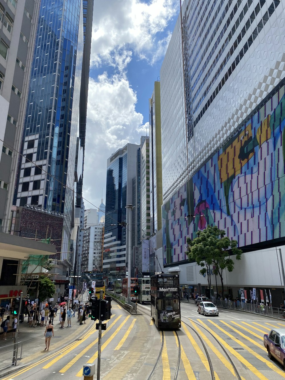 people walking on pedestrian lane near high rise buildings during daytime