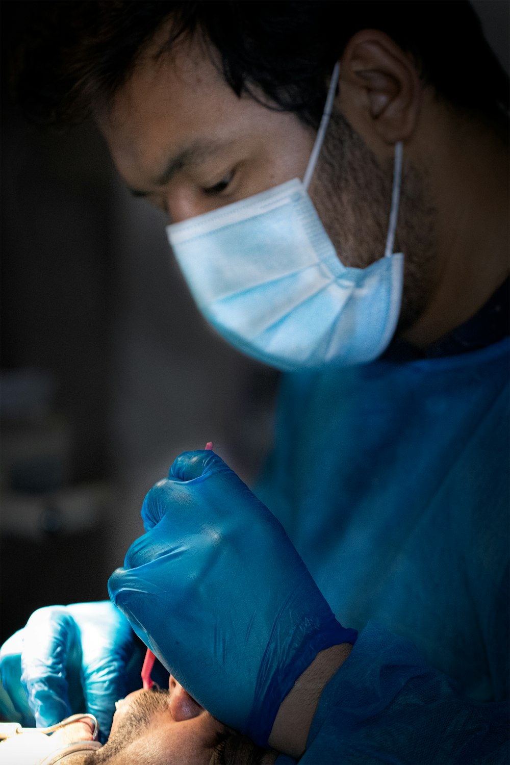 person in blue shirt with white face mask