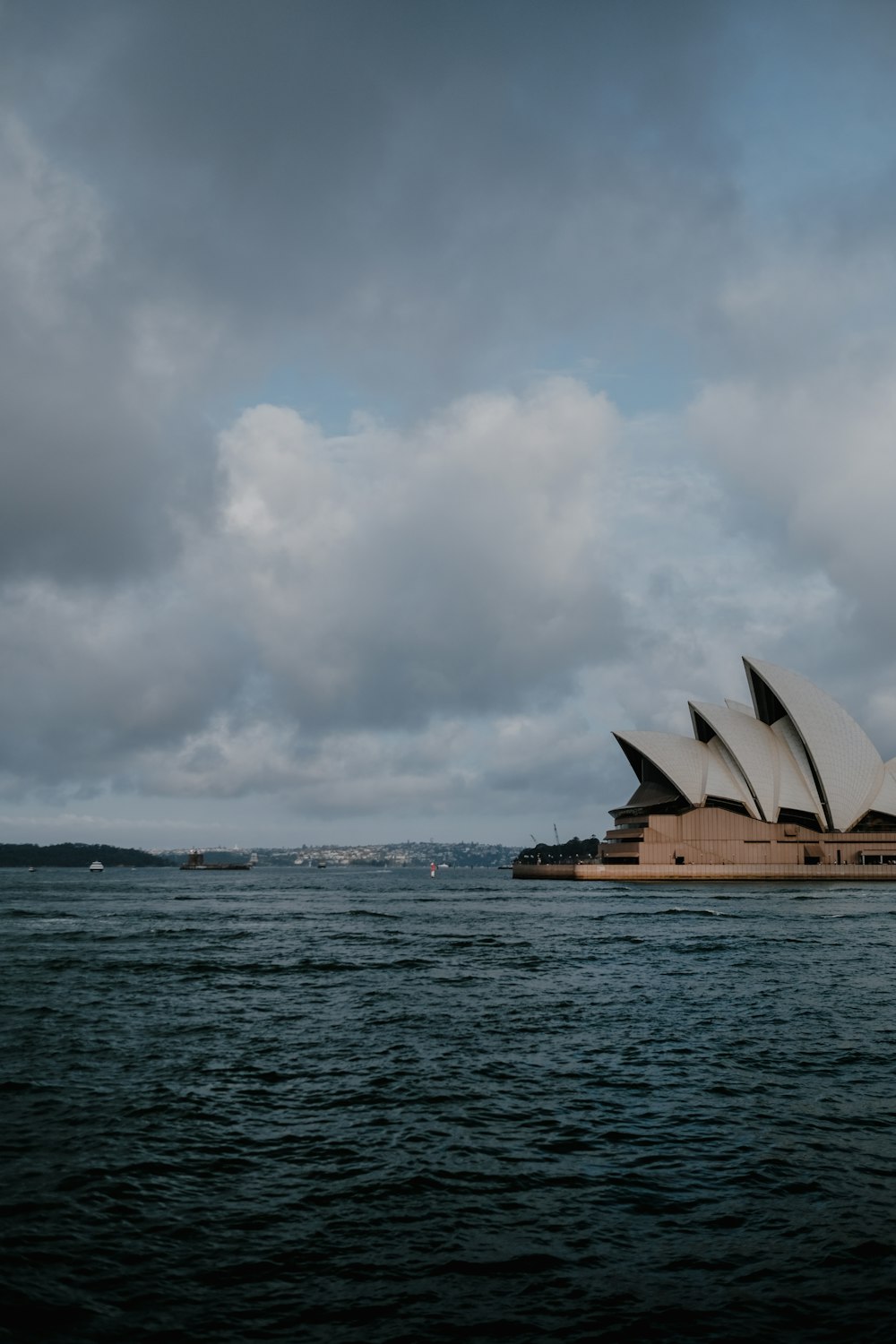 sydney opera house under white clouds during daytime