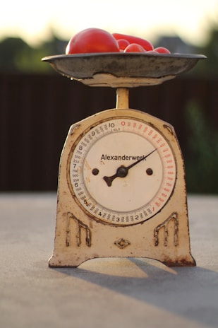 Close-up of a sleek kitchen scale on a modern kitchen counter with fresh ingredients nearby.