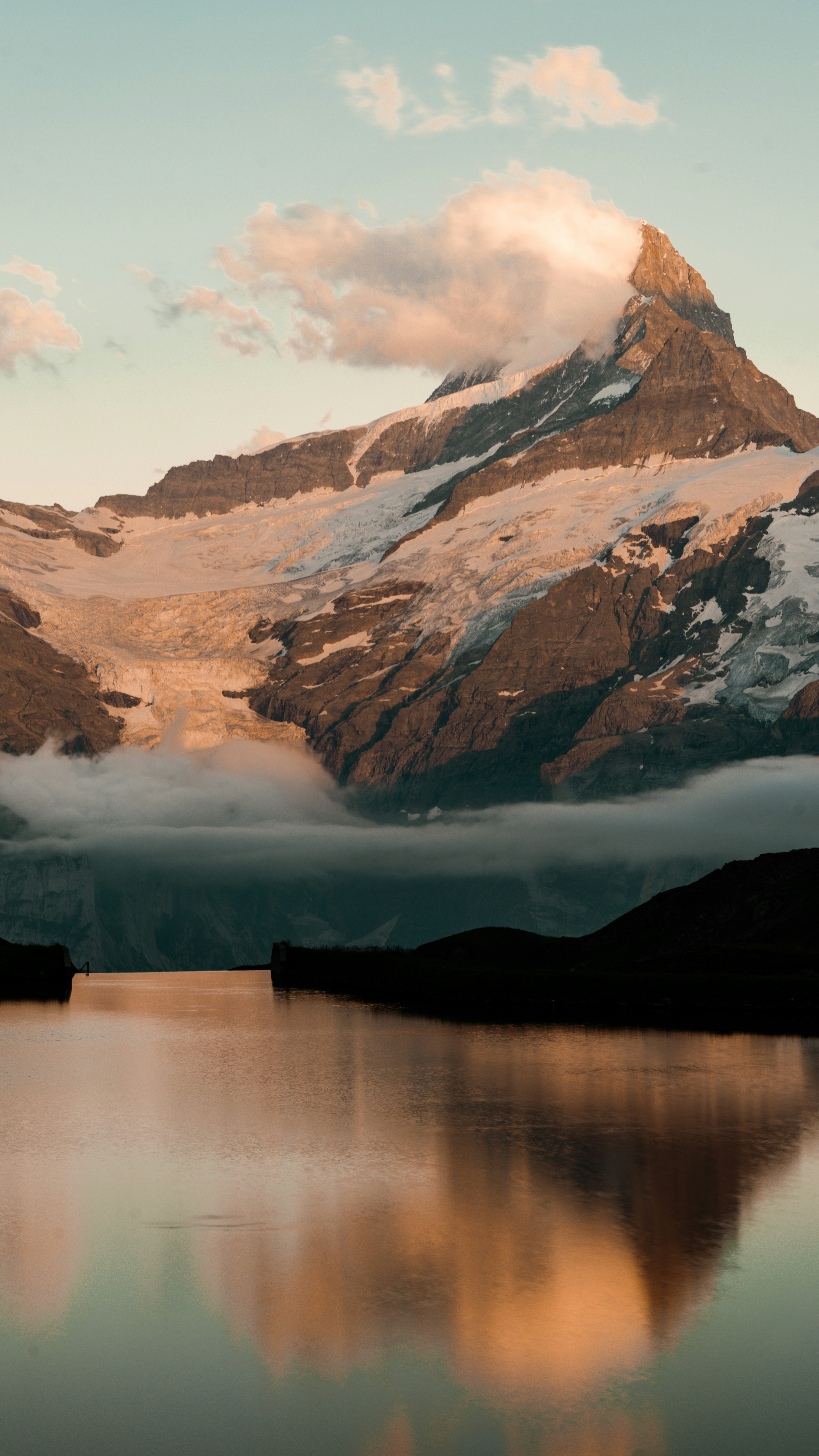 Brown and white mountains near body of water during daytime photo ...