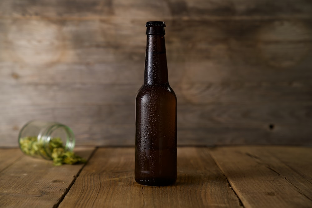brown glass bottle on brown wooden table