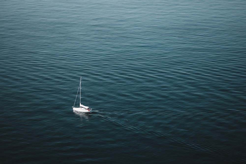 white sailboat on blue sea during daytime