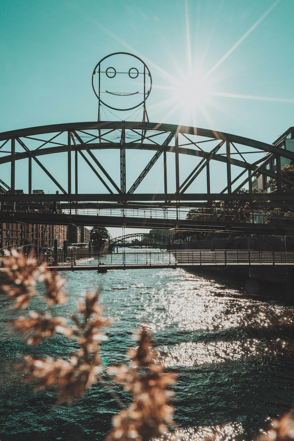 people on bridge over river during daytime