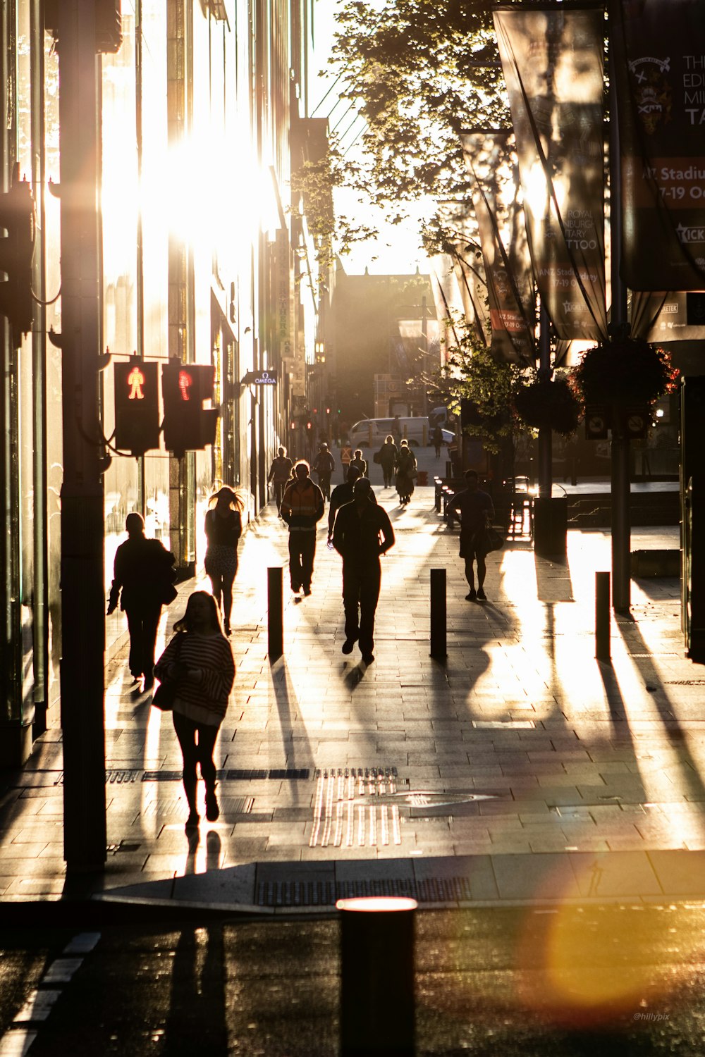 people walking on sidewalk during night time