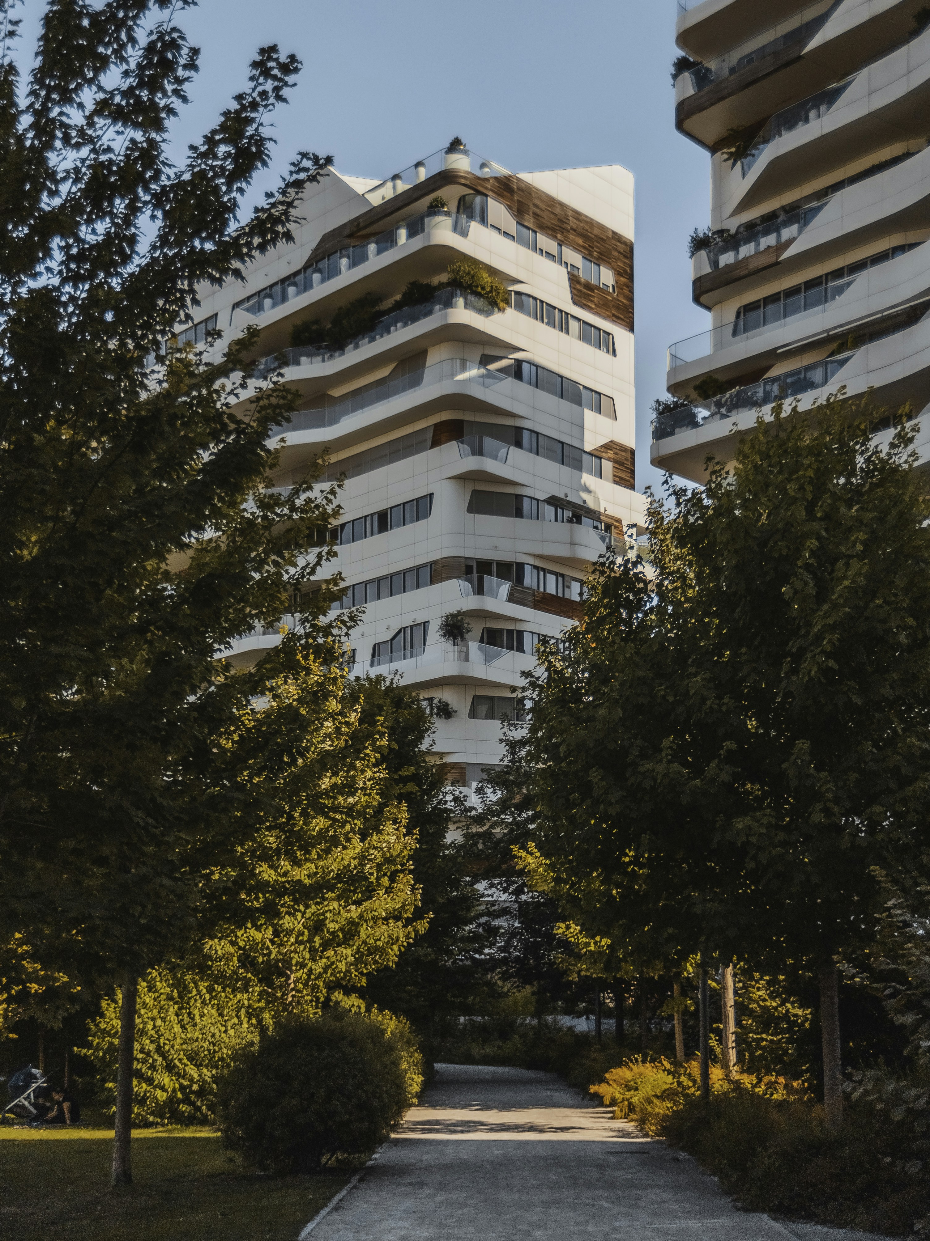 Brown and white concrete building near green trees during daytime photo ...