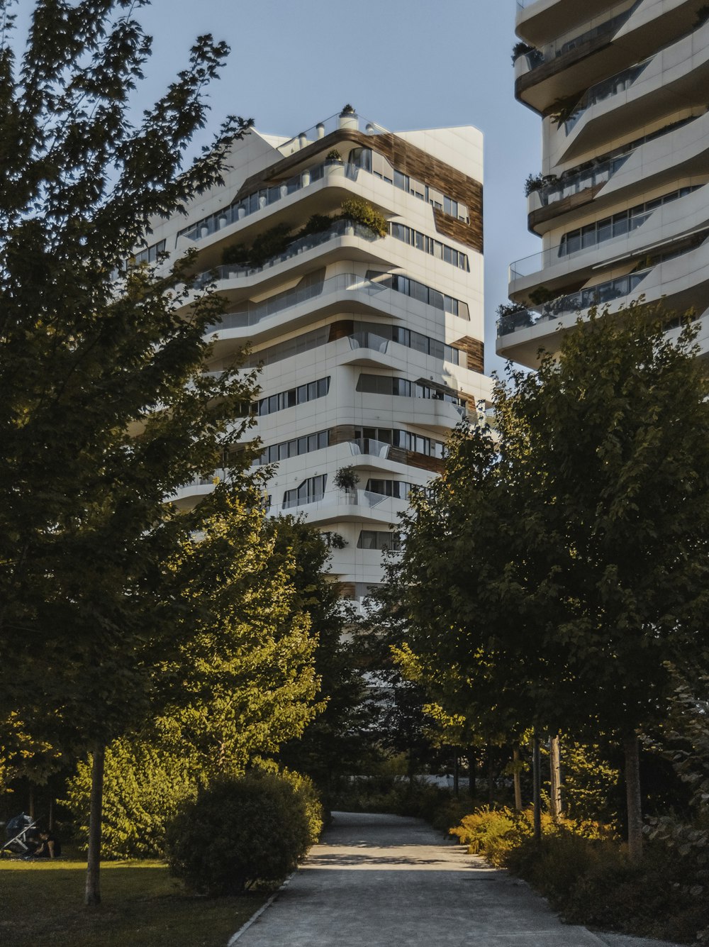 brown and white concrete building near green trees during daytime