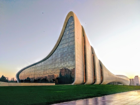 Modern glass-fronted commercial building with clean lines and landscaped surroundings.