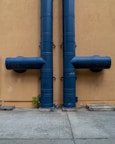 blue rolled textile on brown concrete wall