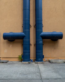 blue rolled textile on brown concrete wall