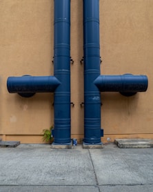 blue rolled textile on brown concrete wall