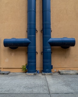 blue rolled textile on brown concrete wall