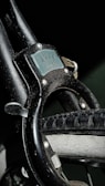 A close-up view of a bike lock attached to a bicycle wheel. The lock is labeled 'Ving 5276' and appears worn, with scratches visible on the surface. The bicycle tire is also detailed, showing the treads and slight wear.