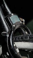 A close-up of a bike lock securing a bicycle.