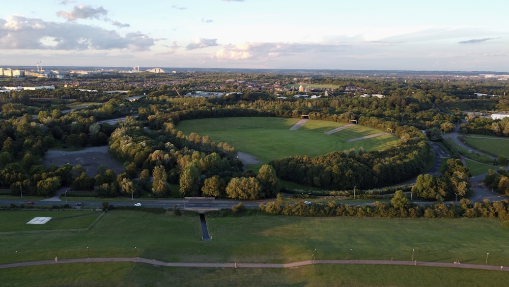 an aerial view of a golf course surrounded by trees